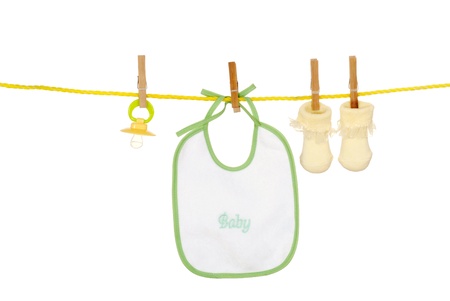 Isolated baby bib socks on a clothes lineの写真素材