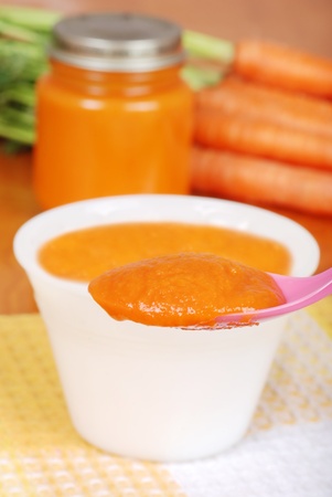 Macro carrot baby food on spoonの写真素材