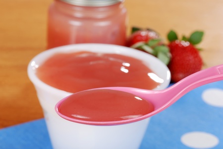 macro spoonful of strawberry baby foodの写真素材
