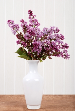 White vase with lilac flowersの写真素材