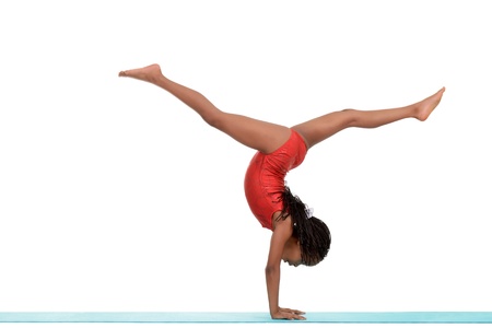 Young black child doing gymnastics front walkoverの写真素材