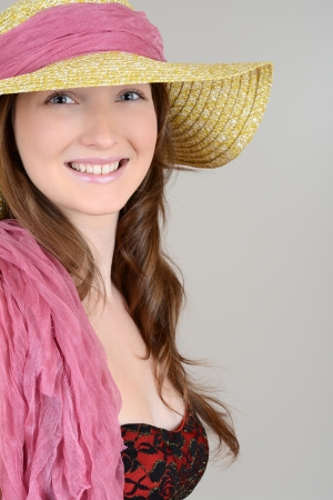 teen with straw hat and pink scarfの写真素材