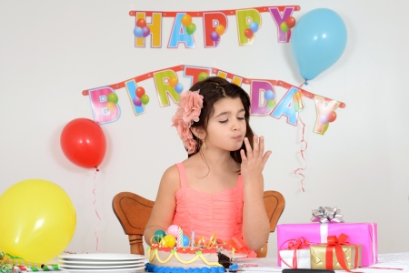 Birthday girl licking her fingersの写真素材