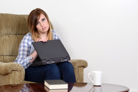 sad teenager with laptopの写真素材
