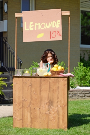bored girl at lemonade standの写真素材