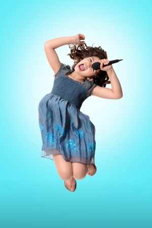 child jumping and singingの写真素材