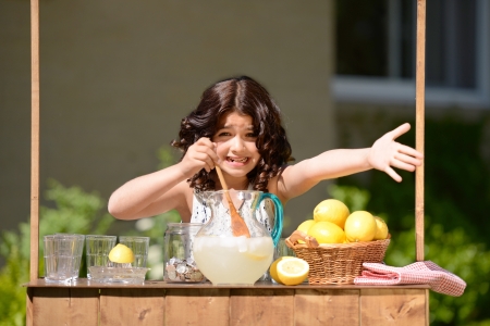 little girl trying to sell lemonadeの写真素材