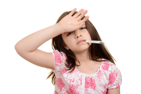 sick child with hand on foreheadの写真素材