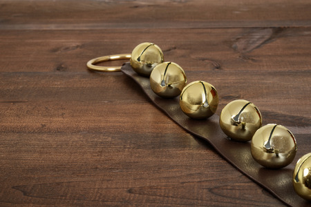 christmas sleigh bells on woodの写真素材