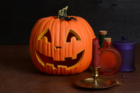 Halloween candle with pumpkin and bottlesの写真素材
