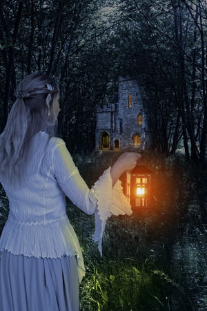female elf in the woods with lanternの写真素材