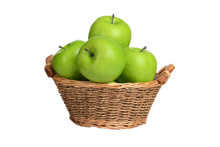 isolated wicker basket of green applesの写真素材