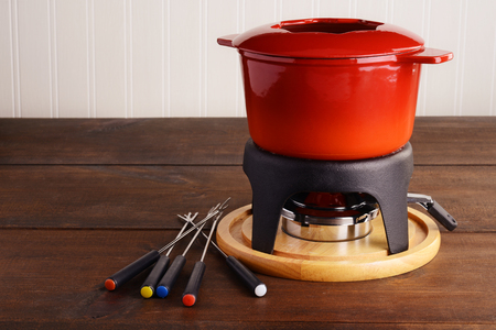 red cast iron fondue pot with skewersの写真素材
