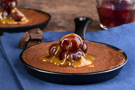 closeup chocolate cake with cherries and caramel sauceの写真素材