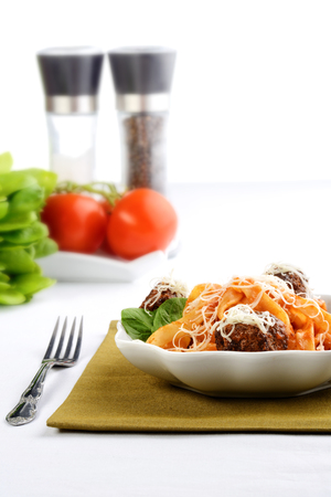 spaghetti and meatballs in a white bowlの写真素材