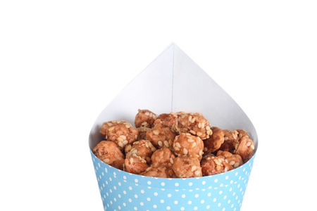 closeup honey sesame seed almonds in a coneの写真素材