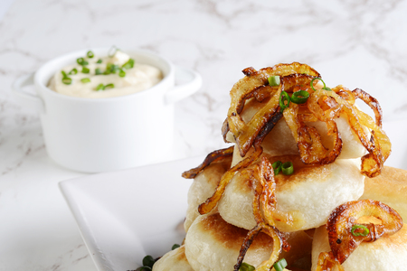 closeup pierogies with sour cream caramelized onionsの写真素材