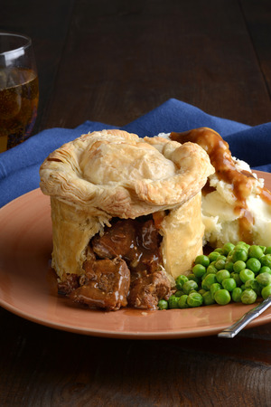 closeup steak pub pie with vegetablesの写真素材