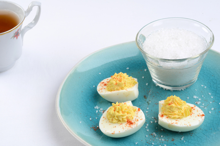 deviled eggs with bowl of saltの写真素材
