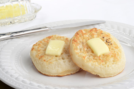 english crumpets with a knifeの写真素材