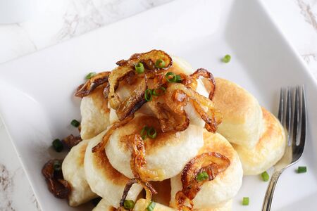 closeup top view pierogies with caramelized onions and a forkの写真素材