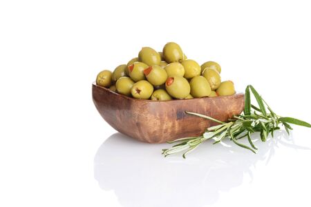 wood bowl of pimento green olives with rosemary herbの写真素材