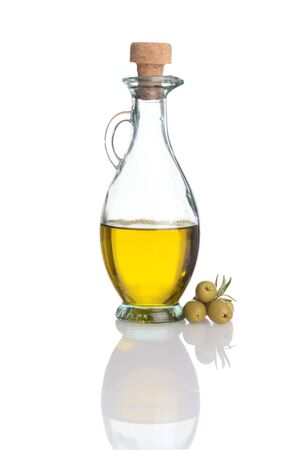 glass bottle of olive oil with fresh green olivesの写真素材