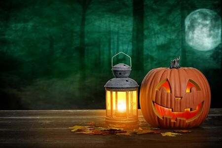 halloween pumpkin and lantern on wood tableの写真素材