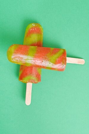 top view strawberry and kiwi ice lollyの写真素材