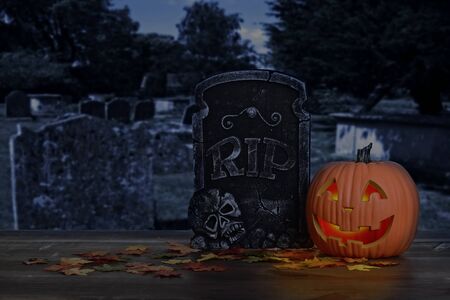 halloween pumpkin glowing in graveyardの写真素材