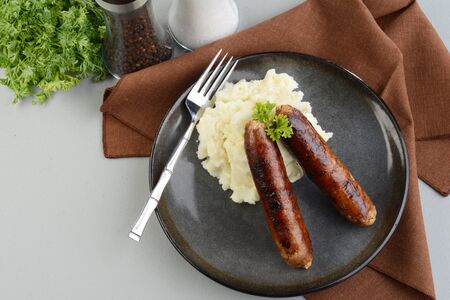 top view chorizo sausages with a fork and parsleyの写真素材