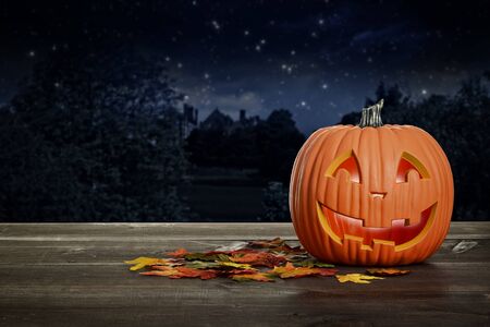 halloween pumpkin glowing on wood tableの写真素材