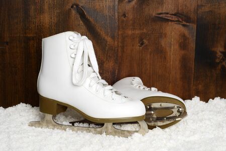 women retro ice skates in snowの写真素材