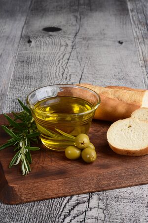 bowl of olive oil with rosemary herb and breadの写真素材
