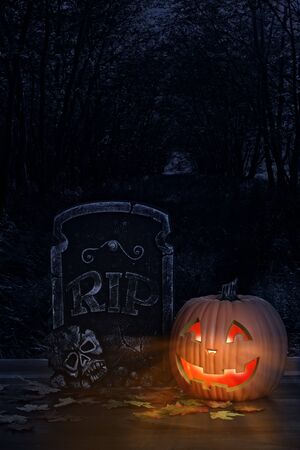 halloween pumpkin with grave headstoneの写真素材
