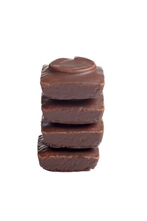 isolated stack of chocolate covered small cakesの写真素材