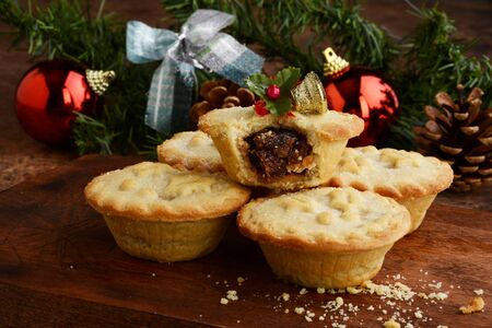 closeup pile of mincemeat pies with christmas ornamentsの写真素材