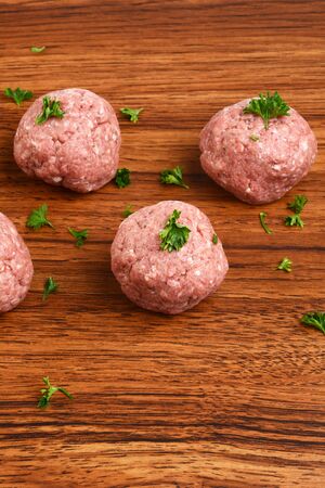 raw meatballs with parsleyの写真素材