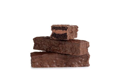 stack of chocolate cream filled bar cakes on whiteの写真素材