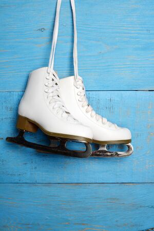 women figure skates on blue woodの写真素材