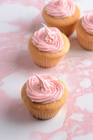pink cupcakes on marble tableの写真素材