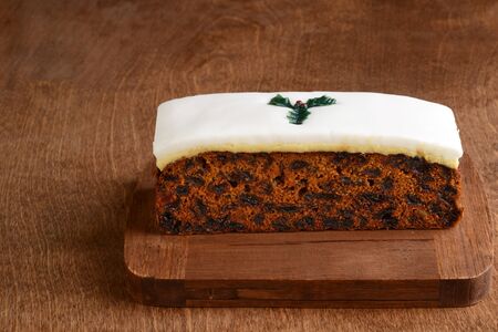 christmas fruitcake with holly decorationの写真素材
