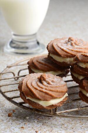 cooling rack with cream filled gingerbread swirl cookiesの写真素材