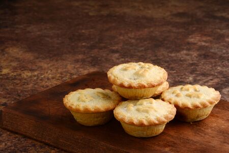 pile of christmas mincemeat pies on woodの写真素材
