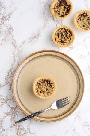 top view fruit crumble tart with a forkの写真素材