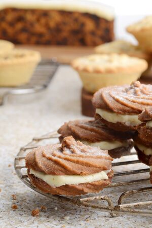closeup gingerbread swirl cookies with christmas baking in backgroundの写真素材