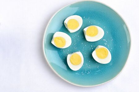high angle view sliced eggs on plateの写真素材