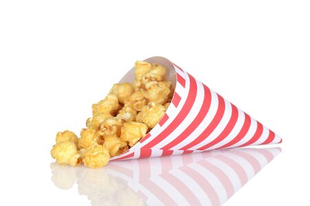 spilled caramel popcorn in a paper coneの写真素材