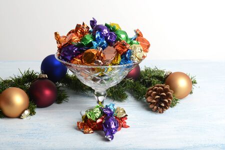 crystal bowl of christmas chocolates with ornamentsの写真素材