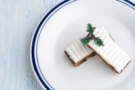 top view christmas fruit cake slices with hollyの写真素材